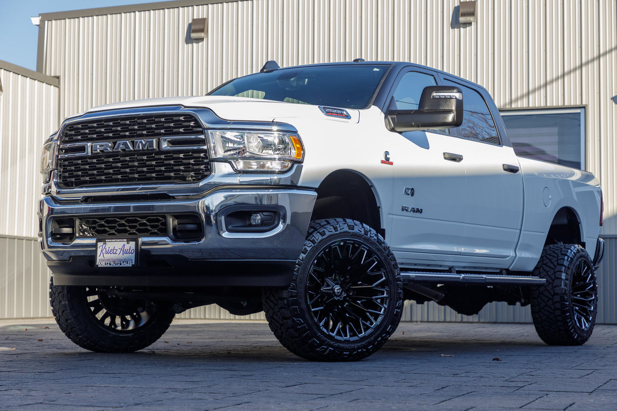 2024 Ram 2500 Big Horn with a 4.5" ReadyLift lift kit, 22x12 Fuel Strike wheels, and 35" Nitto Ridge Grappler tires.