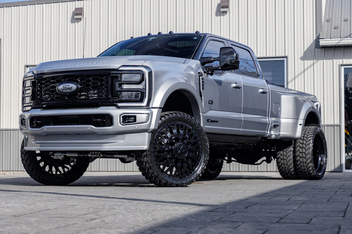 2024 Ford F-450 Super Duty Limited with a 4" Wicked lift kit, 26x8.25 American Force Evo wheels, and AMP Terrain Attack M/T A tires.
