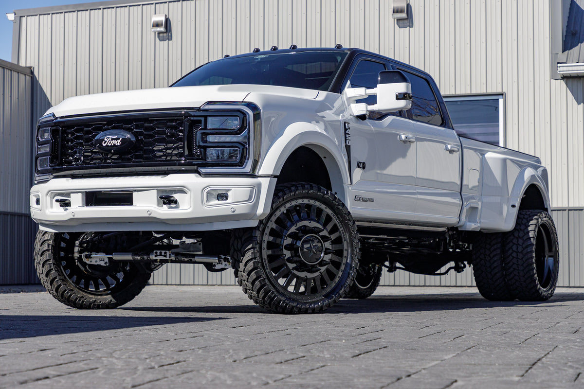 2024 Ford F-450 Super Duty Platinum with a 4" Wicked lift kit, 26x8.25 American Force Doom wheels, and 37" AMP Terrain Attack M/T A tires.