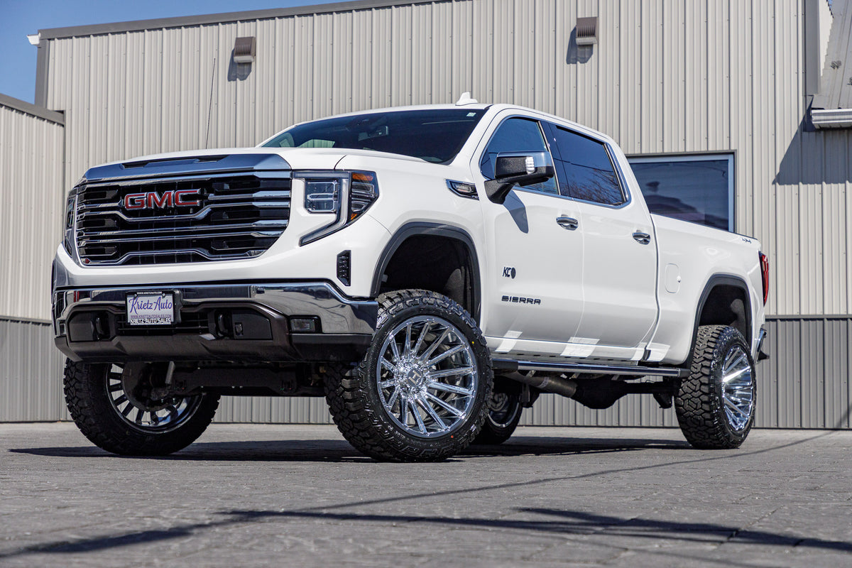 2023 GMC Sierra 1500 SLT with a 6" Rough Country lift kit, 22x12 Hostile Typhoon wheels, and 35" Fury Country Hunter R/T tires.