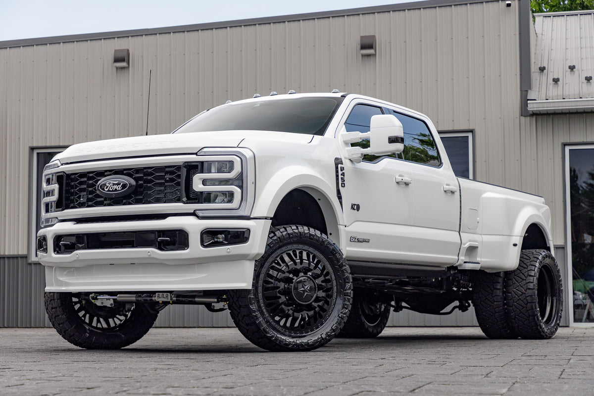 2024 Ford F-450 King Ranch with a 4" Wicked Lift, 24x8.25 American Force Brawn wheels, and 37" Nitto Ridge Grappler wheels .