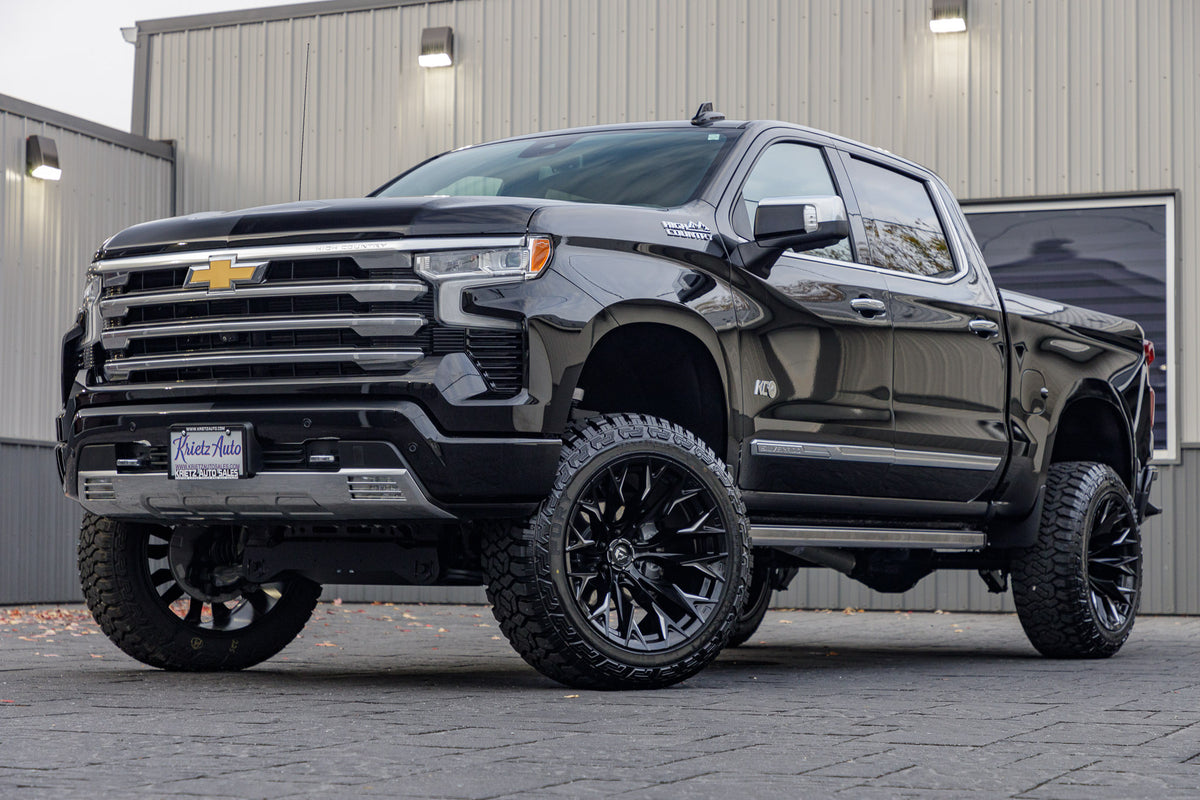 2023 Chevrolet Silverado 1500 High Country with a 6" Rough Country suspension kit, 22x12 Fuel Flame wheels, and 35" Fury Country Hunter R/T tires.