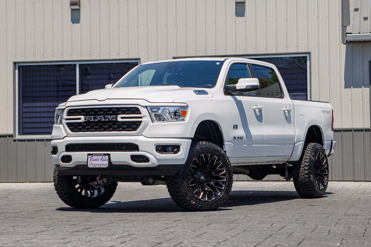 2023 Ram 1500 Big Horn with a 6" Rough Country lift kit, 22x12 Fuel Strike wheels, and 35" Fury Country Hunter R/T tires.