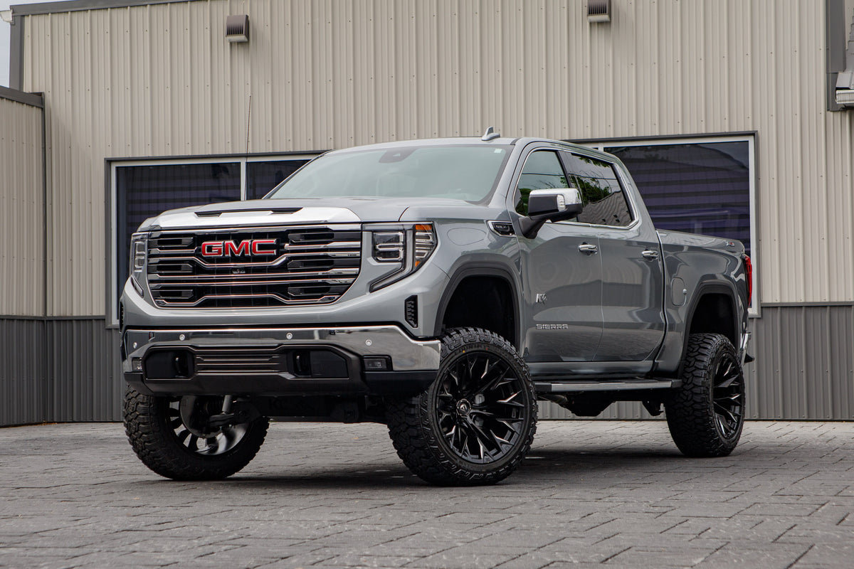 2026 GMC Sierra 1500 SLT with a 6" Rough Country lift kit, 22x12 Fuel Flame wheels, and 35" Fury Country Hunter R/T tires.