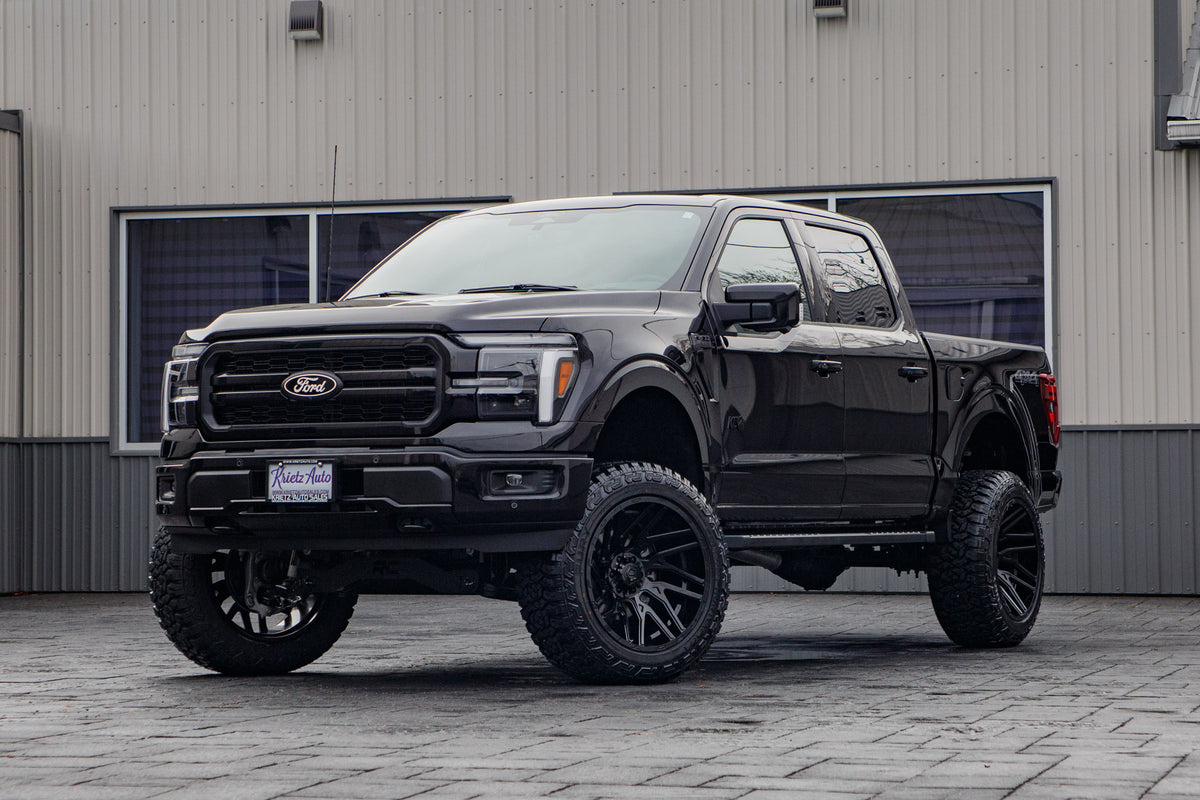 2025 Ford F-150 Lariat with a 6" Rough Country lift kit, 22x12 TIS 554B wheels, and 35" Fury Country Hunter R/T tires.