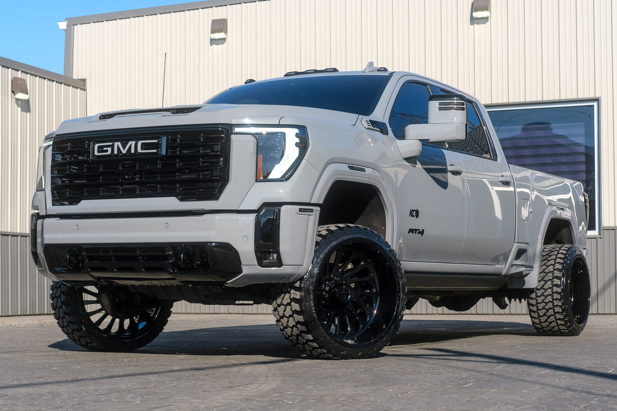 2025 GMC Sierra 3500 AT4 with a 3" Cognito leveling kit, 24x14 American Force Supreme wheels, and 33" Fury Country Hunter M/T tires.
