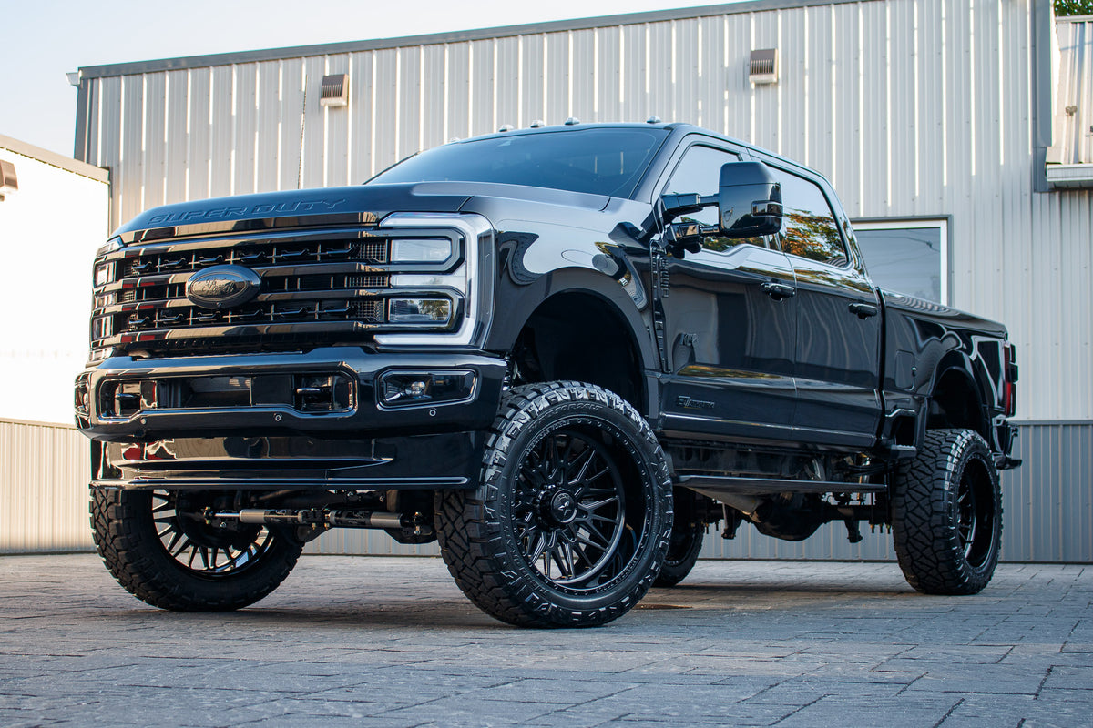 2023 Ford F-250 Super Duty Platinum with a 6" Wicked lift kit, 24x12 American Force Frost wheels, and 37" Nitto Ridge Grappler tires.