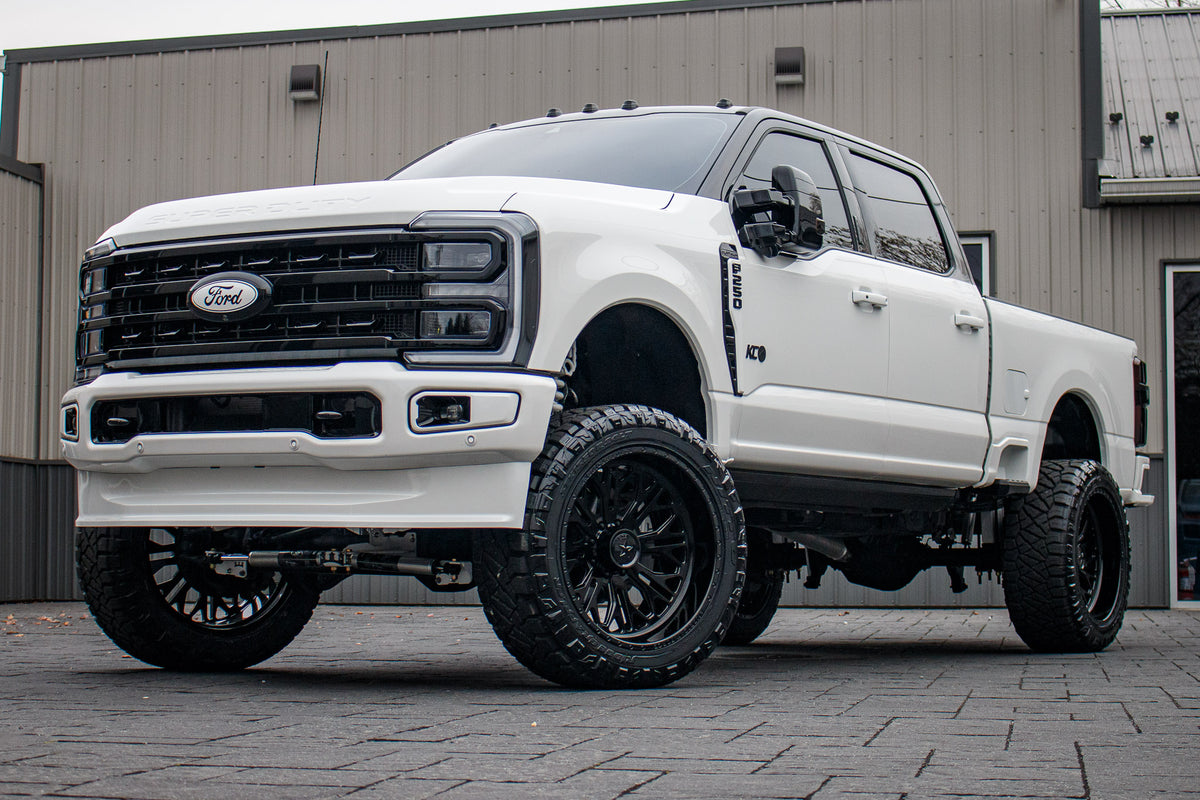2023 Ford F-250 Super Duty Platinum with a 6" Wicked lift kit, 24x12 American Force Intrepid wheels, and 37" Nitto Ridge Grappler tires.
