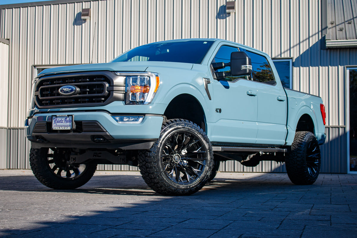 2023 Ford F-150 XLT with a 6" Rough Country lift kit, 22x12 Fuel Flame wheels, and 35" Fury Country Hunter R/T tires.