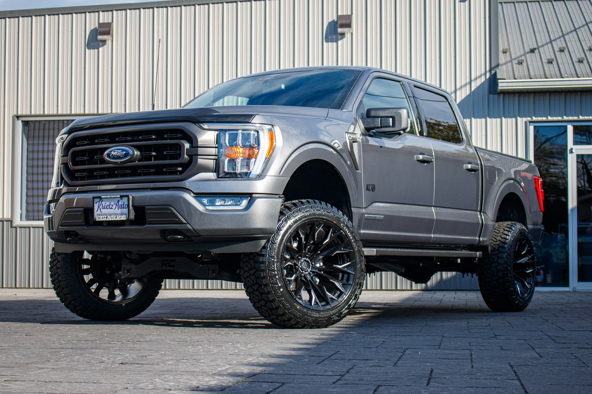 2023 Ford F-150 XLT with a 6" Rough Country lift kit, 22x12 Fuel Flame wheels, and 35" Fury Country Hunter R/T tires.