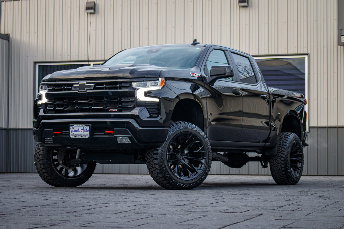2023 Chevrolet Silverado 1500 LT Trail Boss with a 6" Rough Country lift kit, 22x12 Fuel Flame wheels, and 35" Fury Country Hunter R/T tires.