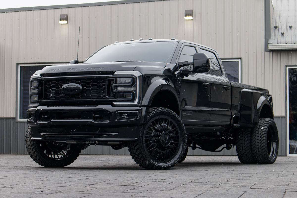 2024 Ford F-450 Super Duty Platinum with a 4" Wicked lift kit, 26x8.25 American Force Plague wheels, and 37" AMP Terrain Attack M/T A tires.