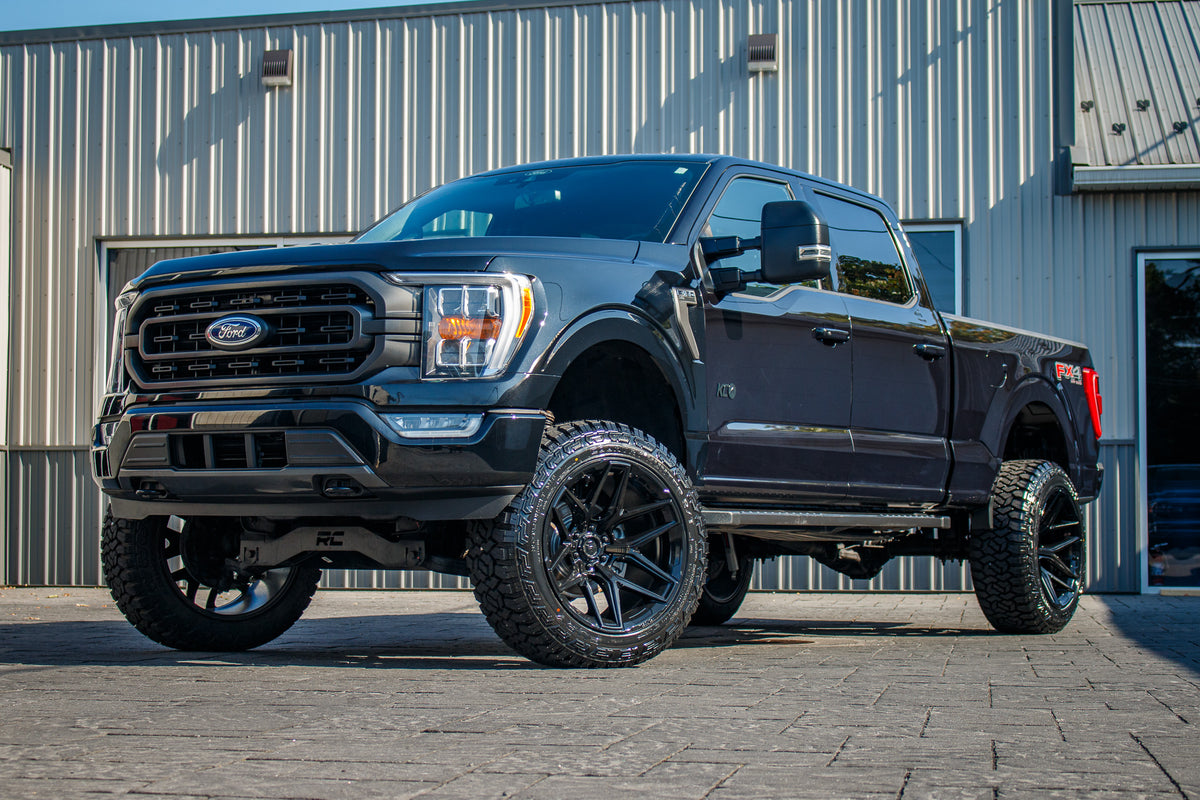 2021 Ford F-150 XLT with a 6" Rough Country lift kit, 22x12 Fuel Flux wheels, and 35" Fury Country Hunter R/T tires.