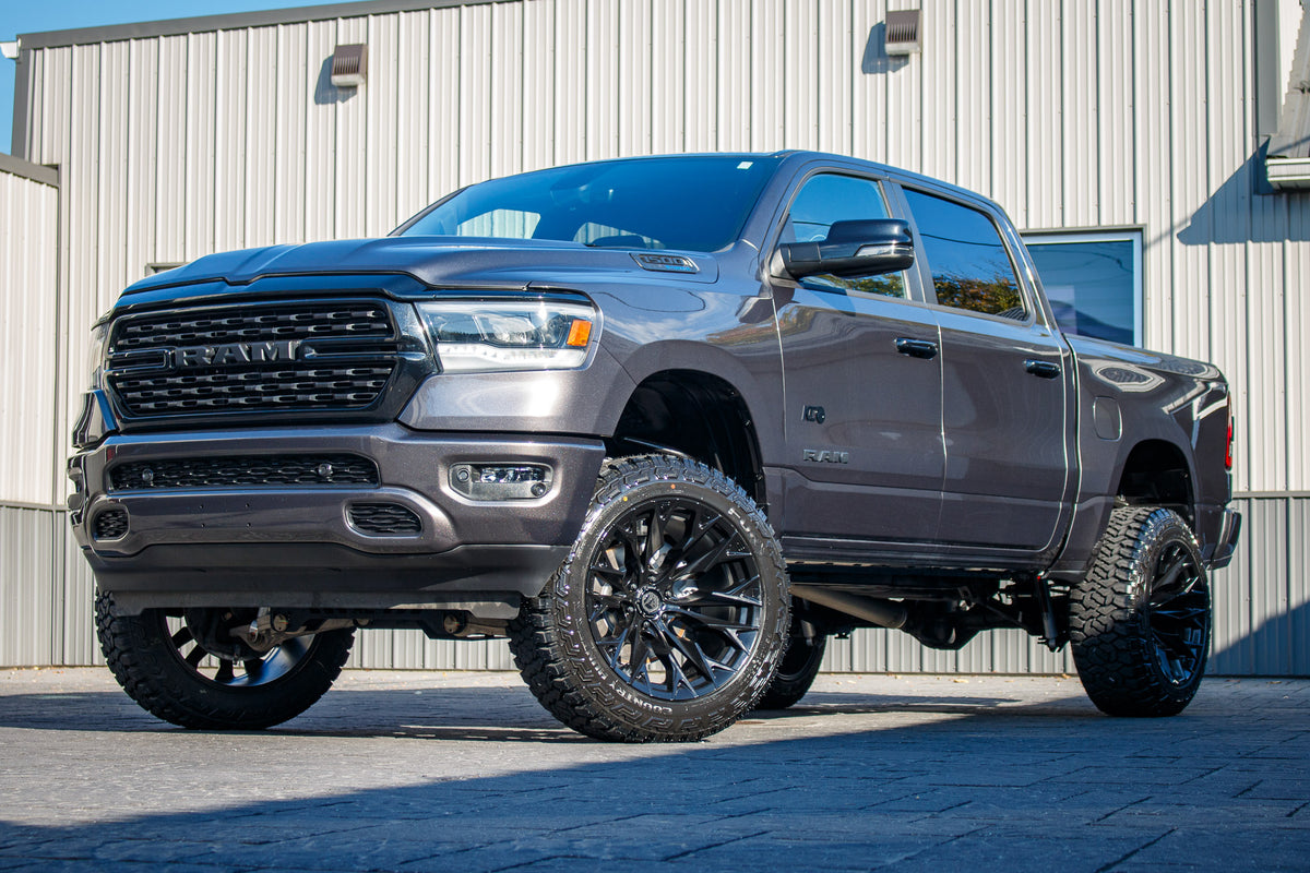 2023 Ram 1500 Big Horn with a 6" Rough Country lift kit, 22x12 Fuel Flame wheels, and 35" Fury Country Hunter R/T tires.