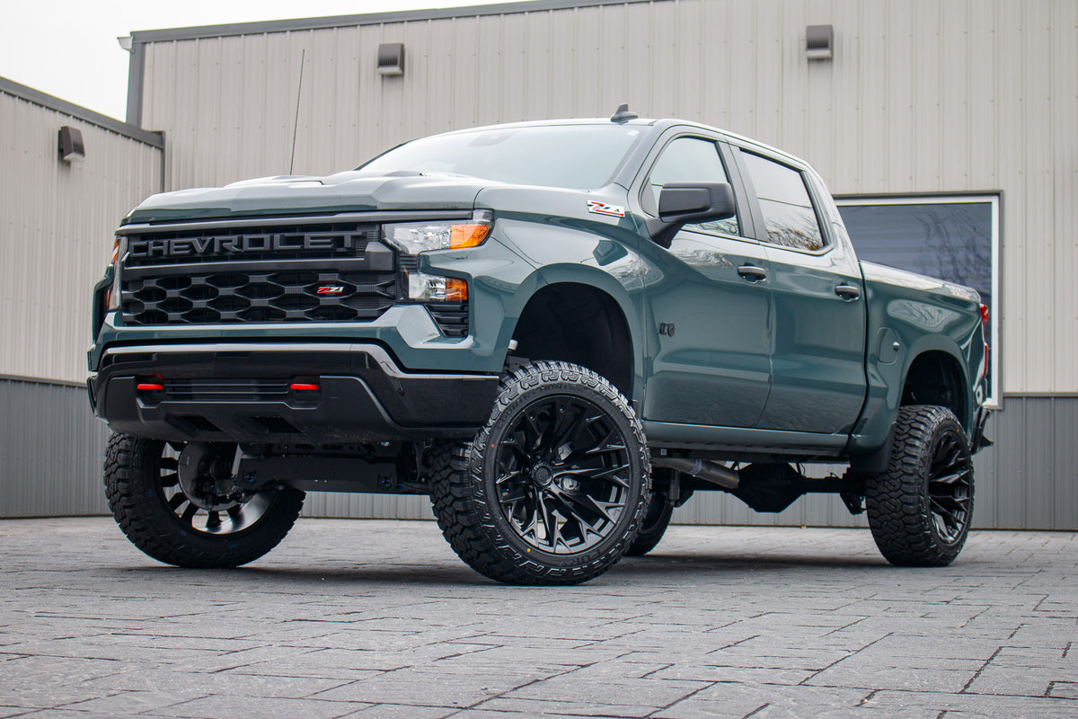 2025 Chevrolet Silverado 1500 Custom Trail Boss with a 6" Rough Country lift kit, 22x12 Fuel Flame wheels, and 35" Fury Country Hunter R/T tires.