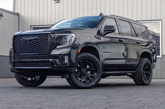 2023 GMC Yukon Denali with a 3" ReadyLift lift kit, 22x10 Fuel Catalyst wheels, and 295/50 Nitto Ridge Grappler tires.