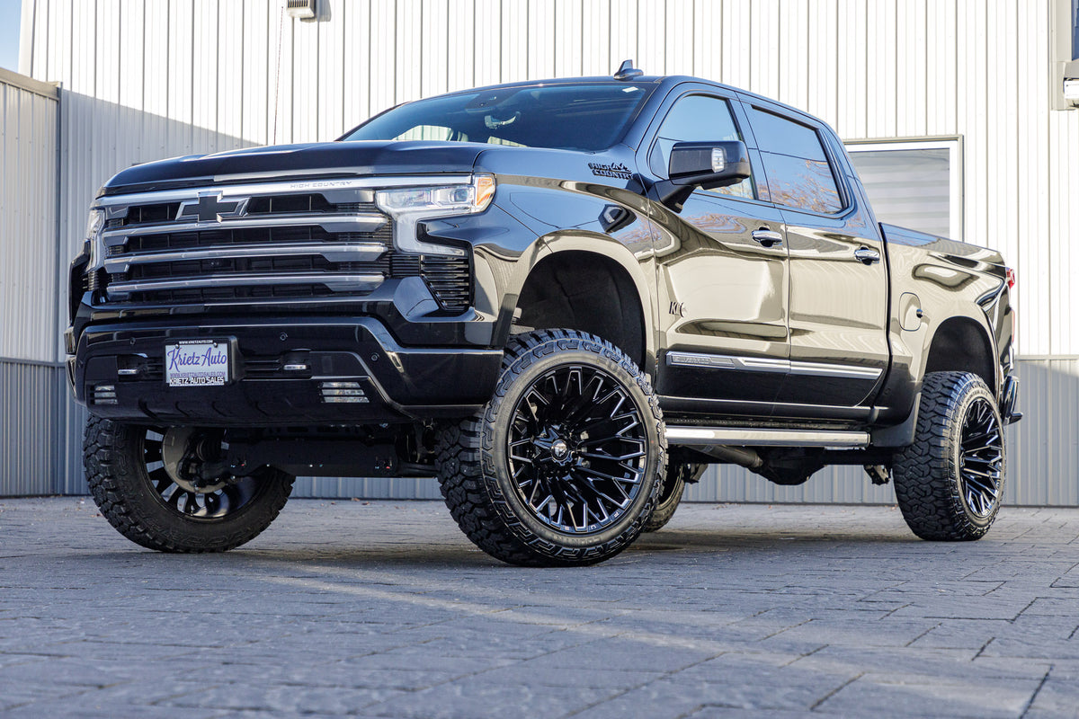 2024 Chevrolet Silverado 1500 High Country with a 6" Rough Country lift kit, 22x12 Fuel Strike wheels, and 35" Fury Country Hunter R/T tires.