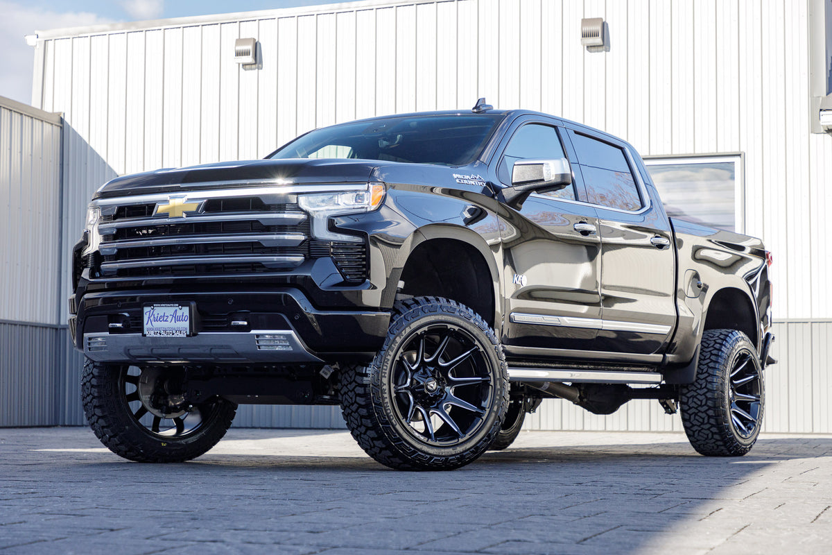 2024 Chevrolet Silverado 1500 High Country with a 6" Rough Country suspension kit, 22x12 Fuel Super C wheels, and 35" Fury Country Hunter R/T tires.