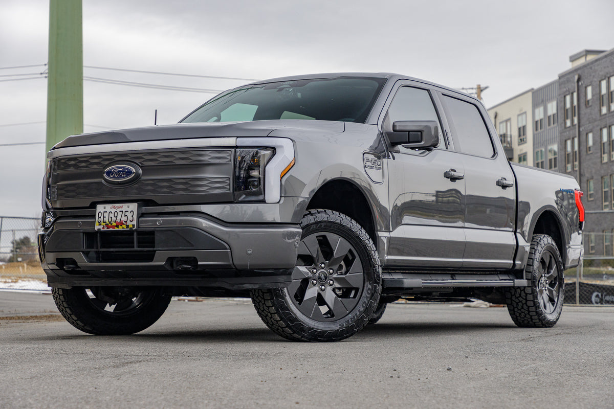 2022 Ford F-150 Lightning Pro with a 2" Rough Country leveling kit, Ford Stock wheels, and 275/60 Toyo Open Country A/T III tires.