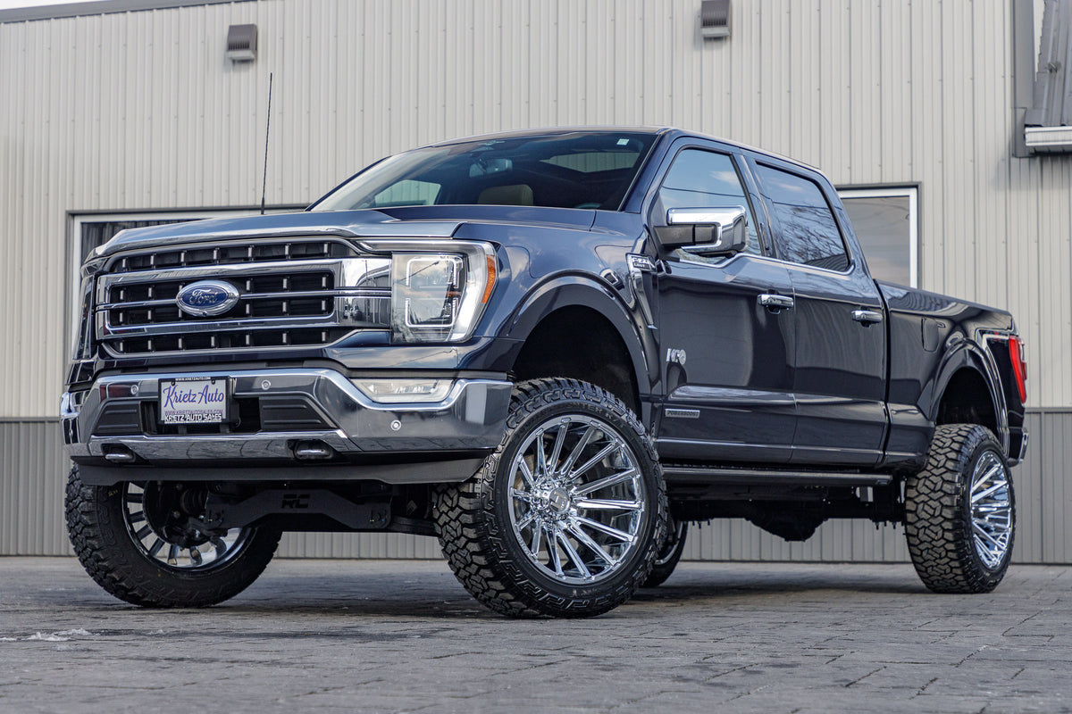 2023 Ford F-150 Lariat with a 6" Rough Country lift kit, 22x12 Hostile Typhoon wheels, and 35" Fury Country Hunter R/T tires.