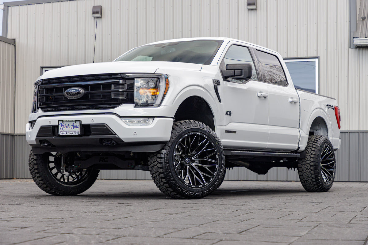 2023 Ford F-150 XLT with a 6" Rough Country lift kit, 22x12 TIS 566BM wheels, and 35" Fury Country Hunter R/T tires.