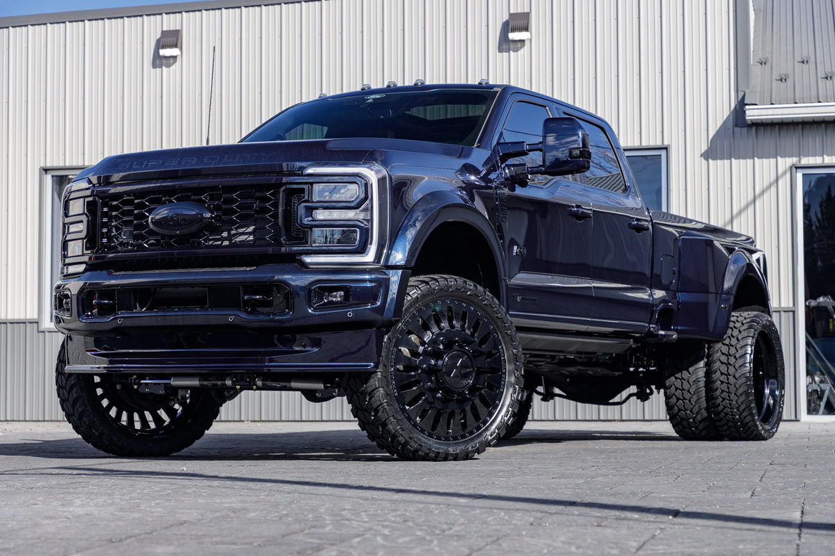 2024 Ford F-450 Super Duty Platinum with a 4" Wicked lift kit, 26x8.25 American Force Massive wheels, and 37" AMP Terrain Attack M/T A tires.
