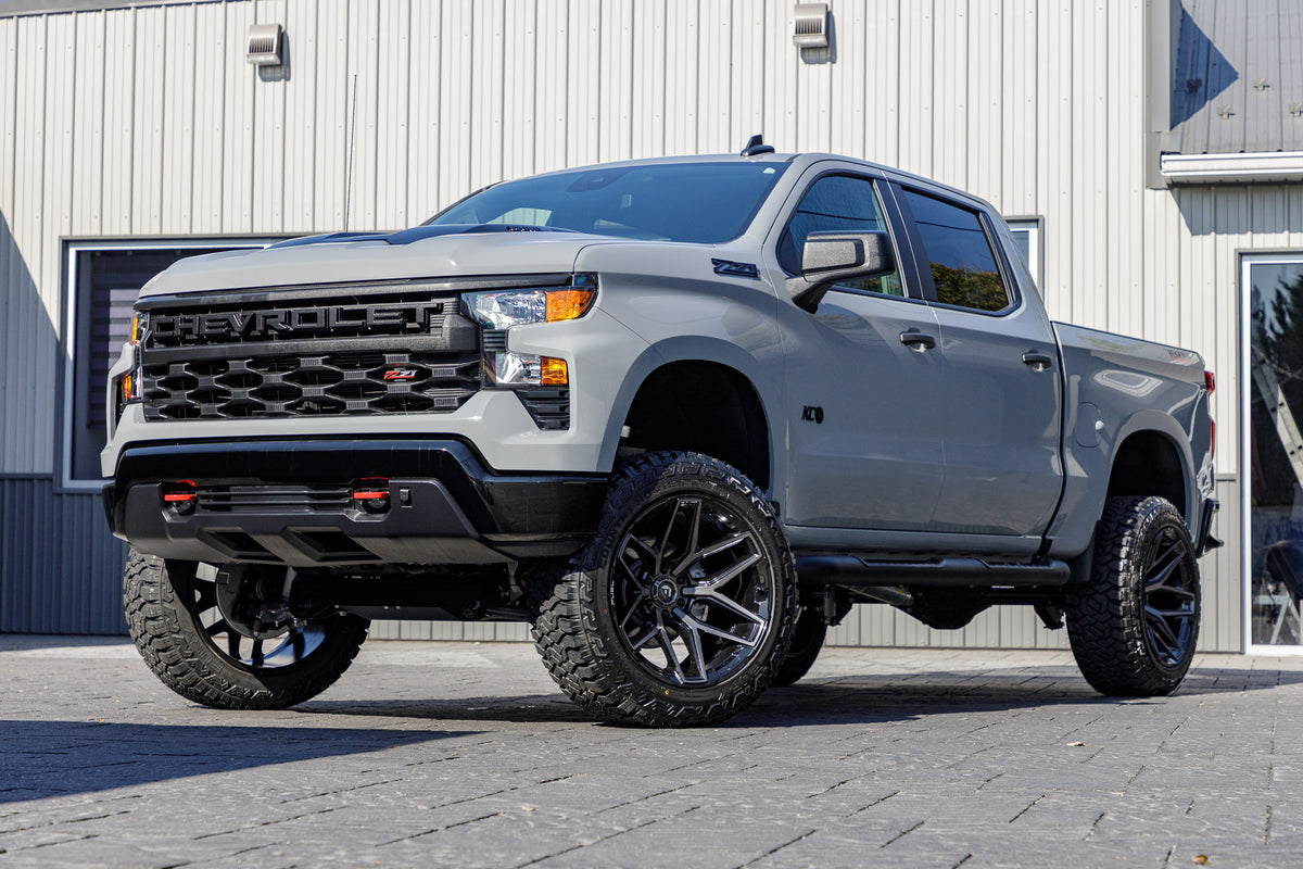 2025 Chevrolet Silverado 1500 Custom Trail Boss with a 6" Rough Country lift kit, 22x12 Fuel Flux wheels, and 35" Fury Country Hunter R/T tires.
