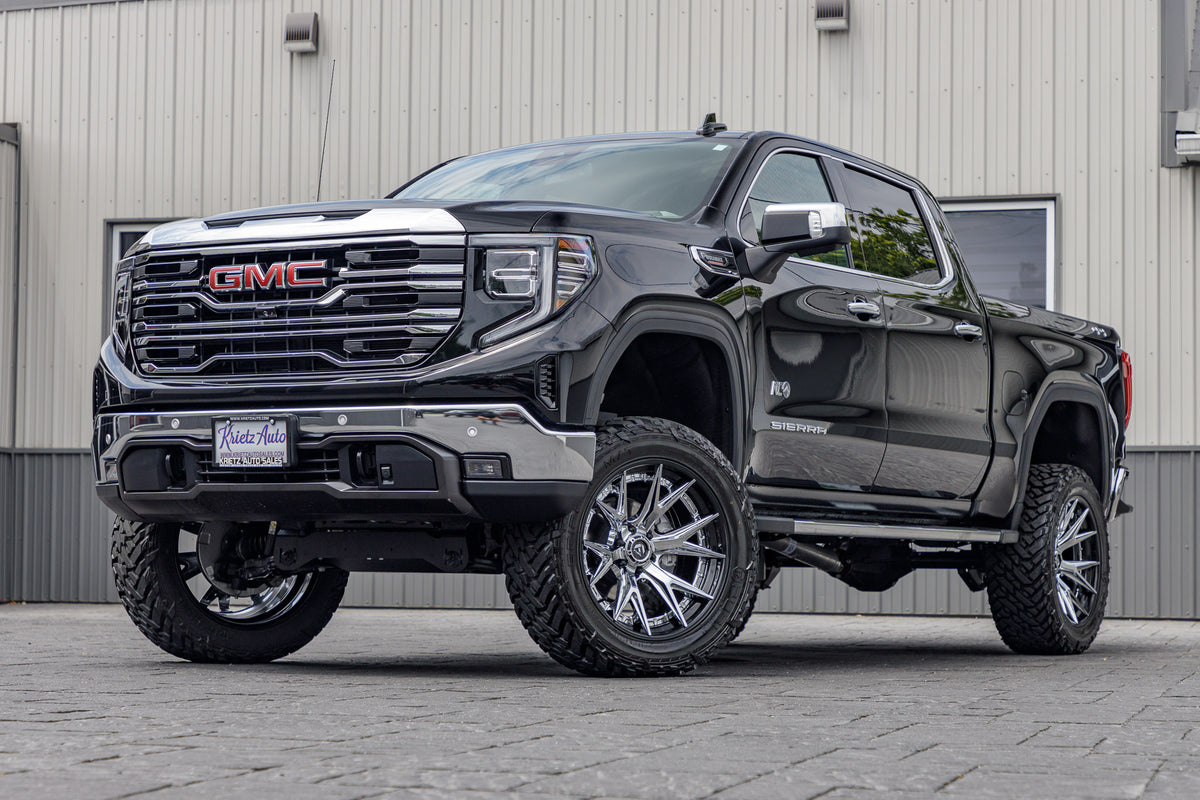 2024 GMC Sierra 1500 SLT Black with 6 inch rough country lift kit and 22x12 fuel catalyst wheels and 35 inch fuel gripper M/T tires
