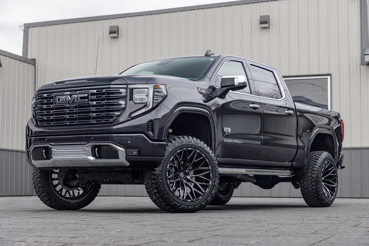 2023 GMC Sierra 1500 Denali Ultimate with a 6" Rough Country lift kit, 22x12 TIS 566BM wheels, and 35" Fury Country Hunter R/T tires.