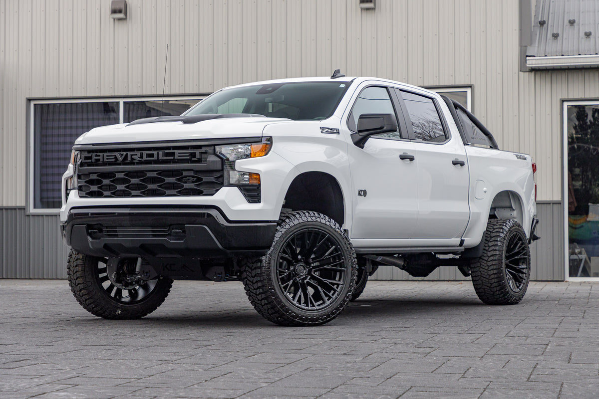 2025 Chevrolet Silverado 1500 Custom Trail Boss with a 6" Rough Country lift kit, 22x12 Fuel Rebar wheels, and 35" Avix Trailtek R/T tires.