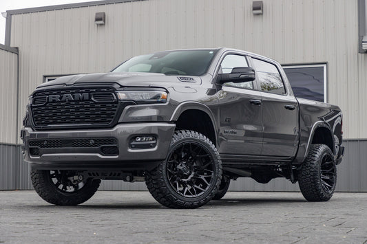 2025 Ram 1500 Big Horn with a 6" Rough Country lift kit, 22x12 Fuel Twitch wheels, and 35" Fury Country Hunter R/T tires.