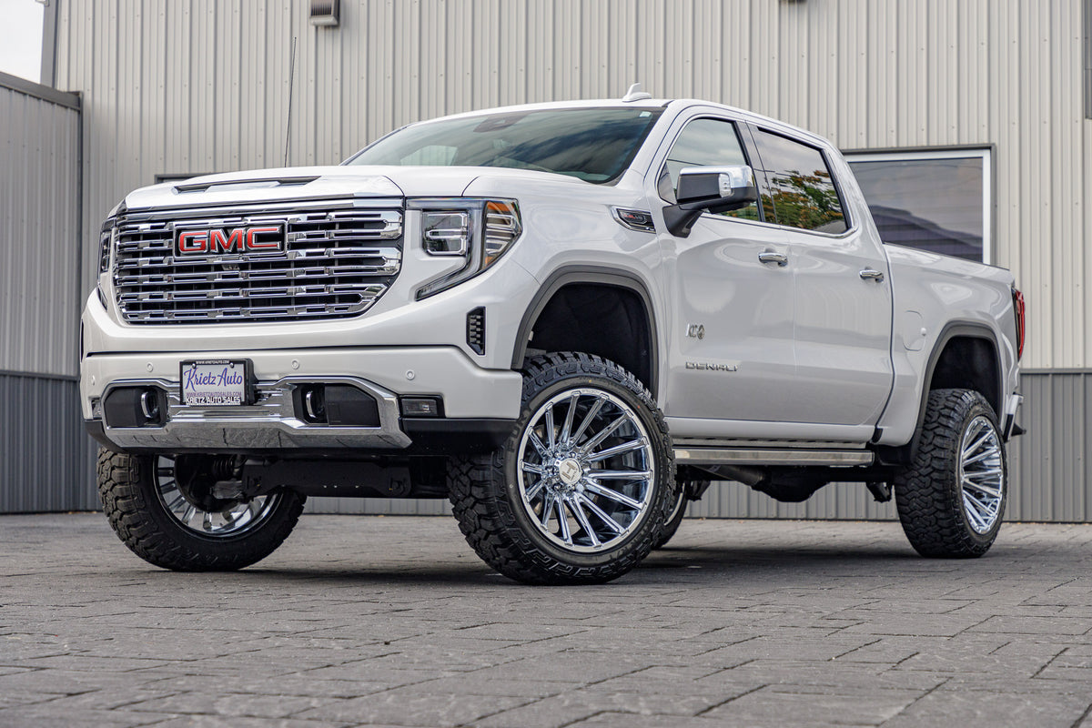2023 GMC Sierra 1500 Denali with a 6" Rough Country suspension kit, 22x12 Hostile Typhoon wheels, and 35" Fury Country Hunter R/T tires.