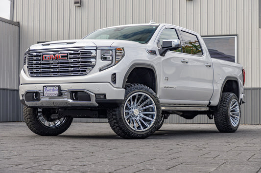 2023 GMC Sierra 1500 Denali with a 6" Rough Country suspension kit, 22x12 Hostile Typhoon wheels, and 35" Fury Country Hunter R/T tires.