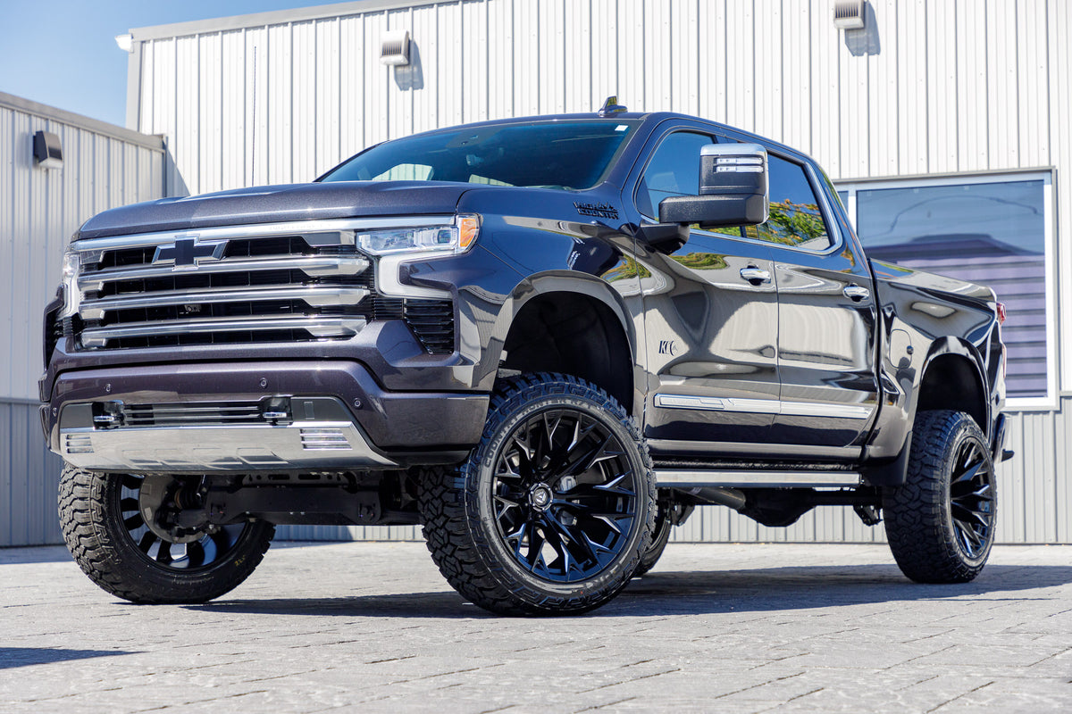 2023 Chevrolet Silverado 1500 High Country with a 6" Rough Country suspension kit, 22x12 Fuel Flame wheels, and 35" Fury Country Hunter R/T tires.