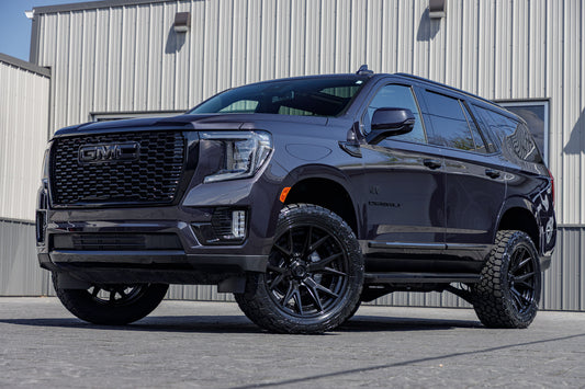 2024 GMC Yukon Denali with a 3" ReadyLift lift kit, 22x10 Fuel Catalyst wheels, and 295/50 Toyo Open Country A/T III tires.