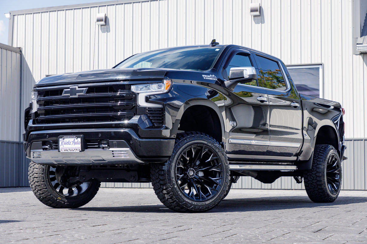 2023 Chevrolet Silverado 1500 High Country with a 6" Rough Country suspension kit, 22x12 Fuel Flux wheels, and 35" Fury Country Hunter R/T tires.