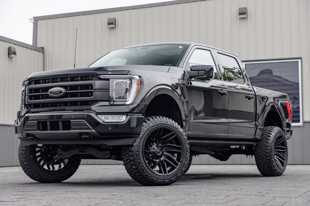 2023 Ford F-150 Lariat with a 6" Rough Country lift kit, 22x12 Fuel Typhoon wheels, and 35" Fury Country Hunter R/T tires.