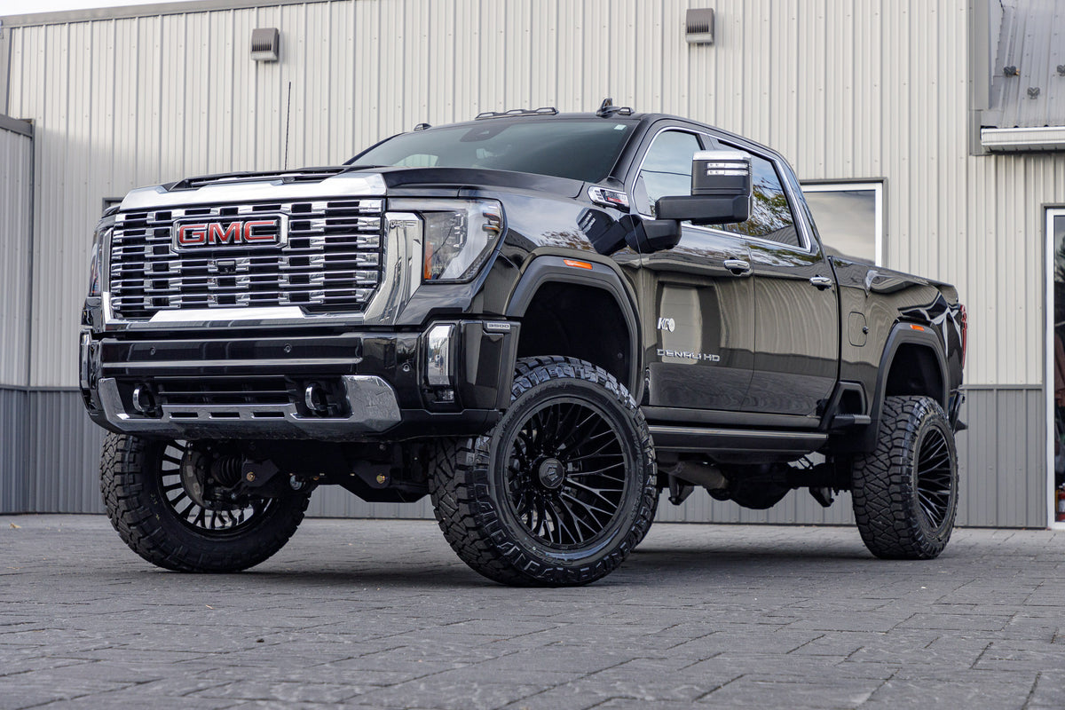 2024 GMC Sierra 3500 Denali with a 5" BDS lift kit, 22x12 TIS 566B wheels, and 37" Nitto Ridge Grappler tires.