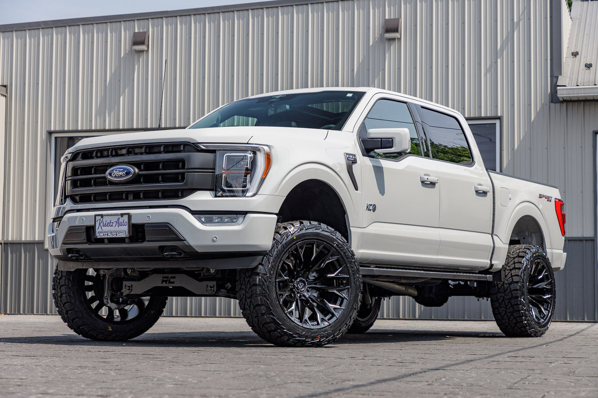 2023 Ford F-150 XLT with a 6" Rough Country lift kit, 22x12 Fuel Flame wheels, and 35" AMP Terrain Attack R/T tires.