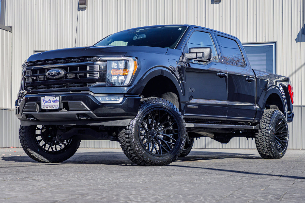 2023 Ford F-150 XLT with a 6" Rough Country lift kit, 22x12 TIS 566B wheels, and 35" Fury Country Hunter R/T tires.