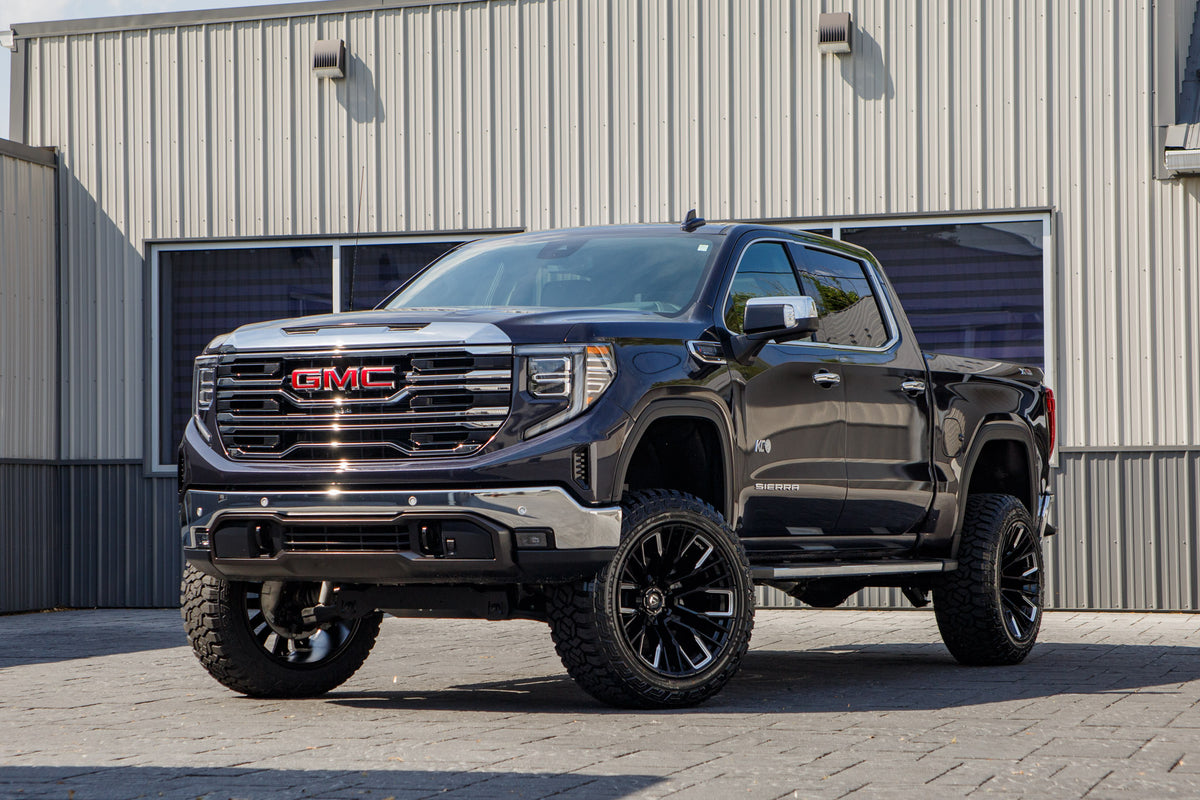 2026 GMC Sierra 1500 SLT with a 6" Rough Country lift kit, 22x12 Fuel Rebar wheels, and 35" Fury Country Hunter R/T tires.