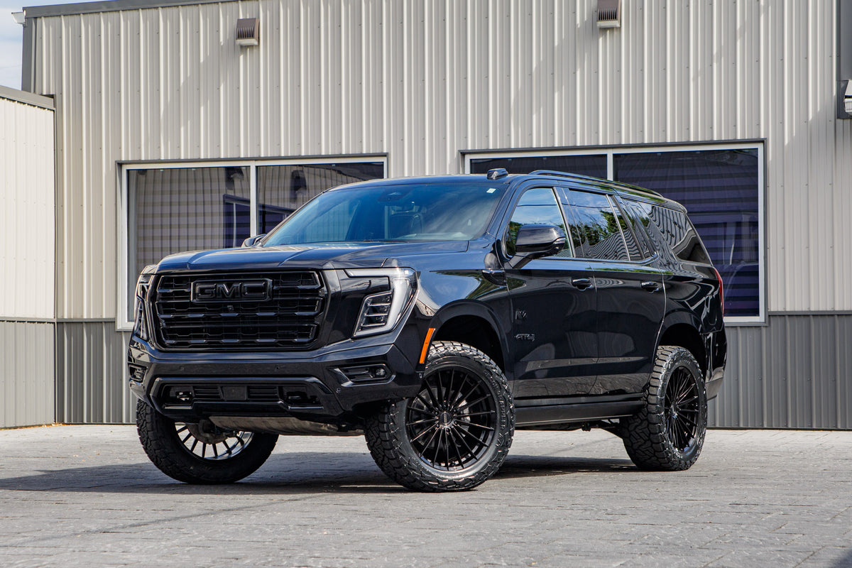 2026 GMC Yukon AT4 Ultimate with a 2" Rough Country lift kit, 22x9.5 Vossen HFX4 wheels, and 35" Nitto Recon Grappler A/T tires.