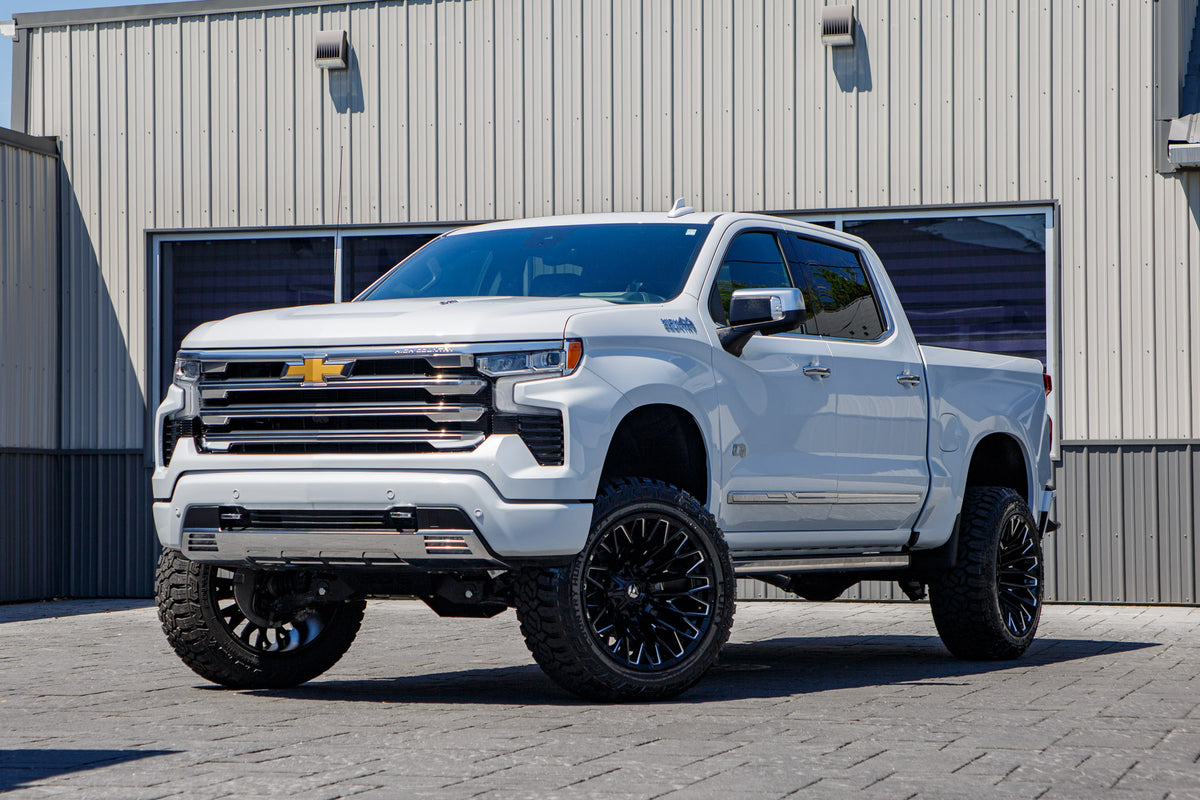 2026 Chevrolet Silverado 1500 High Country with a 6" Rough Country lift kit, 22x12 Fuel Strike wheels, and 35" Fury Country Hunter R/T tires.