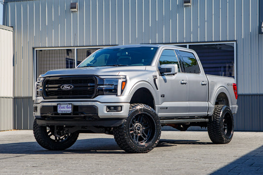 2026 Ford F-150 Lariat with a 6" suspension kit, 22x12 Weld Crutch wheels, and 35" AMP Terrain Attack A/T A tires.