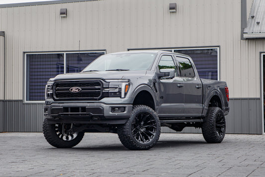 2026 Ford F-150 Lariat with a 6" Rough Country lift kit, 22x12 Fuel Flame wheels, and 35" Fury Country Hunter R/T tires.