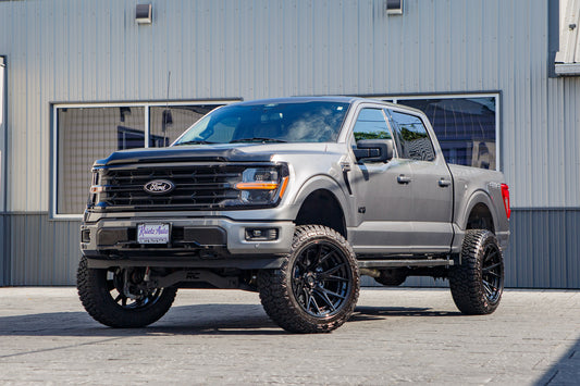2025 Ford F-150 XLT with a 6" Rough Country lift kit, 22x12 Fuel Catalyst wheels, and 35" Fury Country Hunter R/T tires.