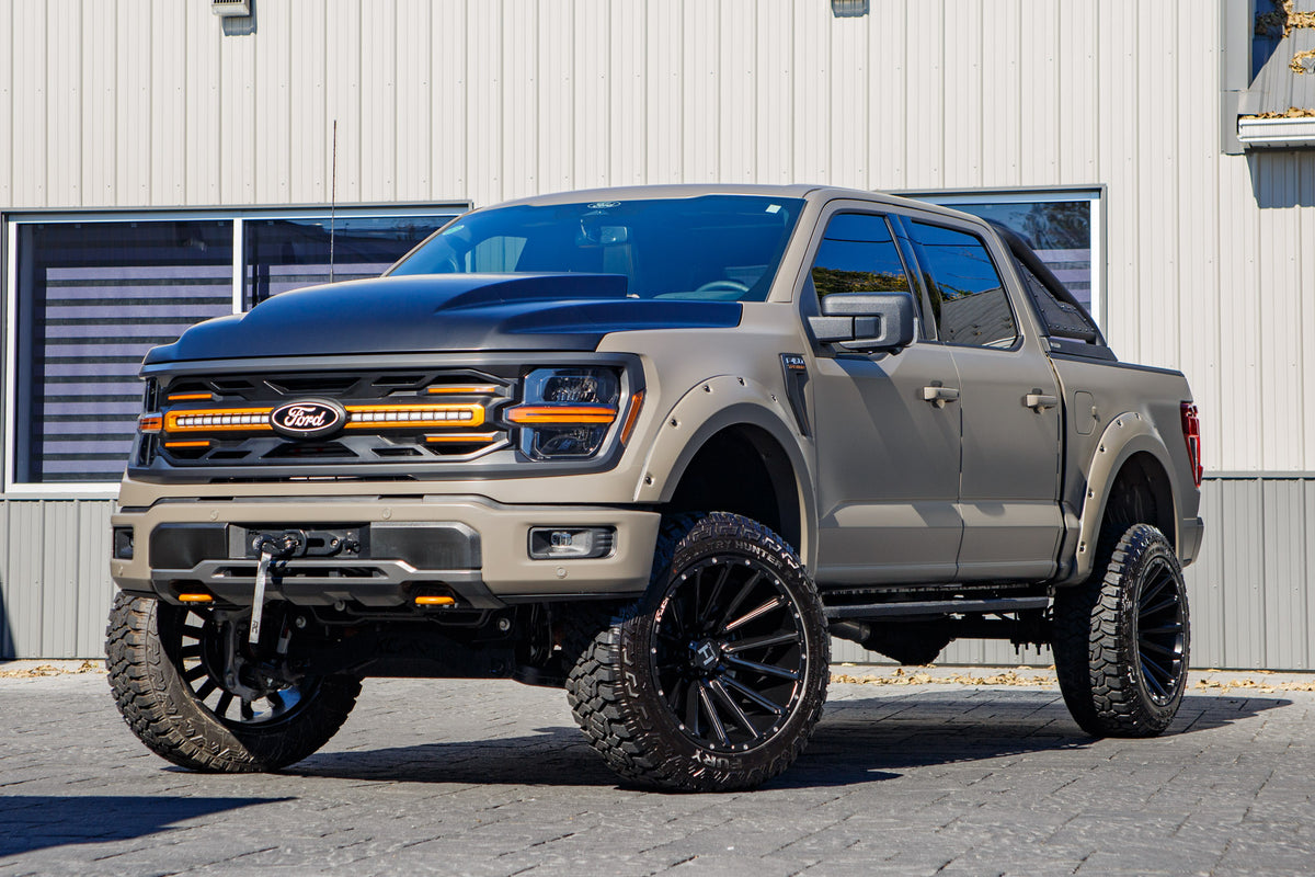 2026 Ford F-150 Tremor with a 6" Rough Country lift kit, 22x12 Hostile H123 wheels, and 35" Fury Country Hunter R/T tires.