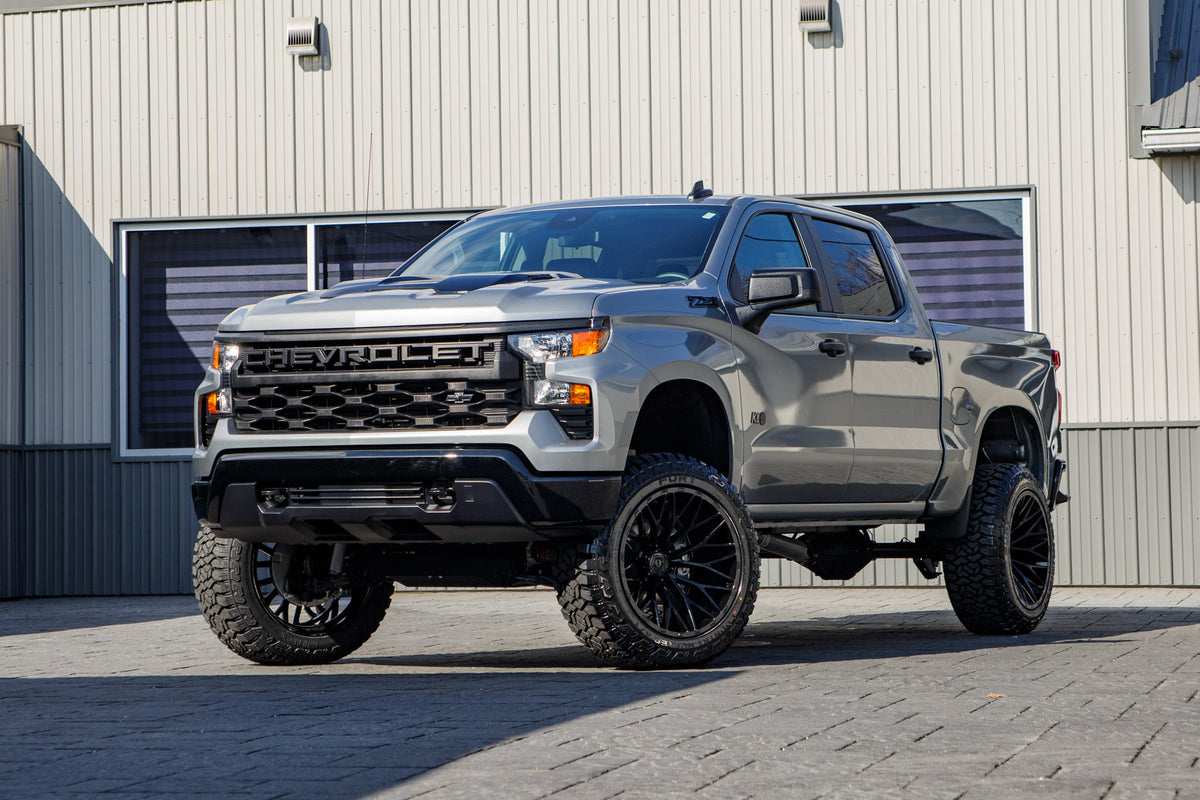2025 Chevrolet Silverado 1500 Custom Trail Boss with a 6" Rough Country lift kit, 22x12 TIS 566B wheels, and 35" Fury Country Hunter R/T tires.