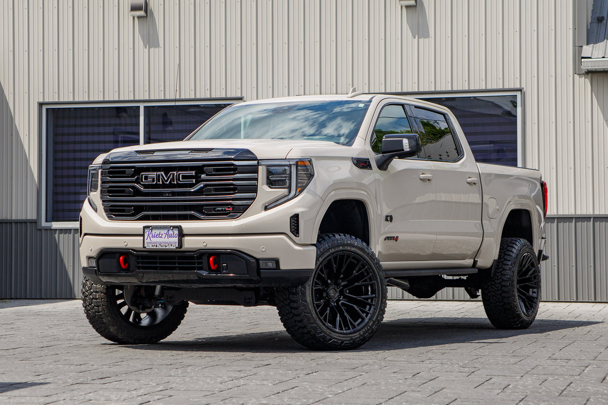 2026 GMC Sierra 1500 AT4 with a 6" Rough Country lift kit, 22x12 Fuel Rebar wheels, and 35" Fury Country Hunter R/T tires.
