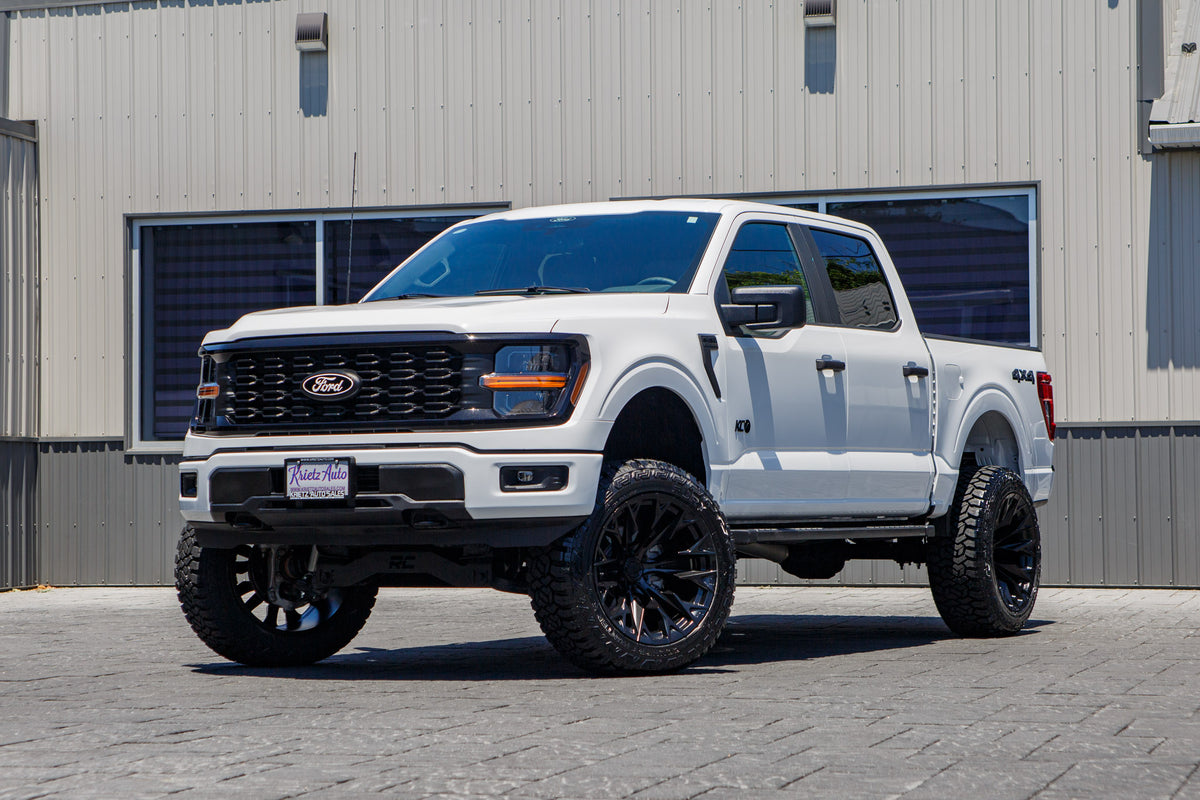 2025 Ford F-150 STX with a 6" Rough Country lift kit, 22x12 Fuel Flame wheels, and 35" Fury Country Hunter R/T tires.
